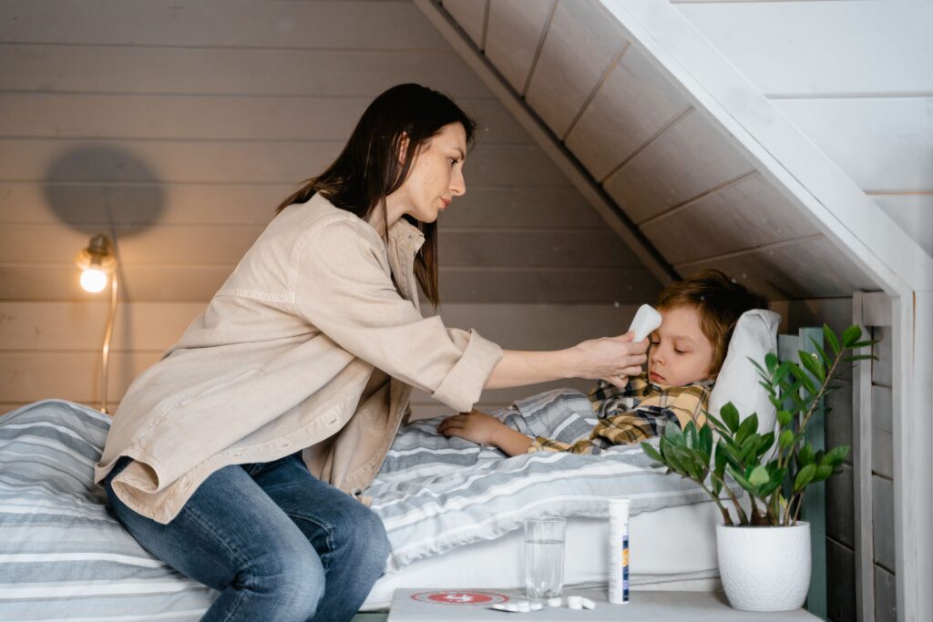 Woman helping a sick child in a room