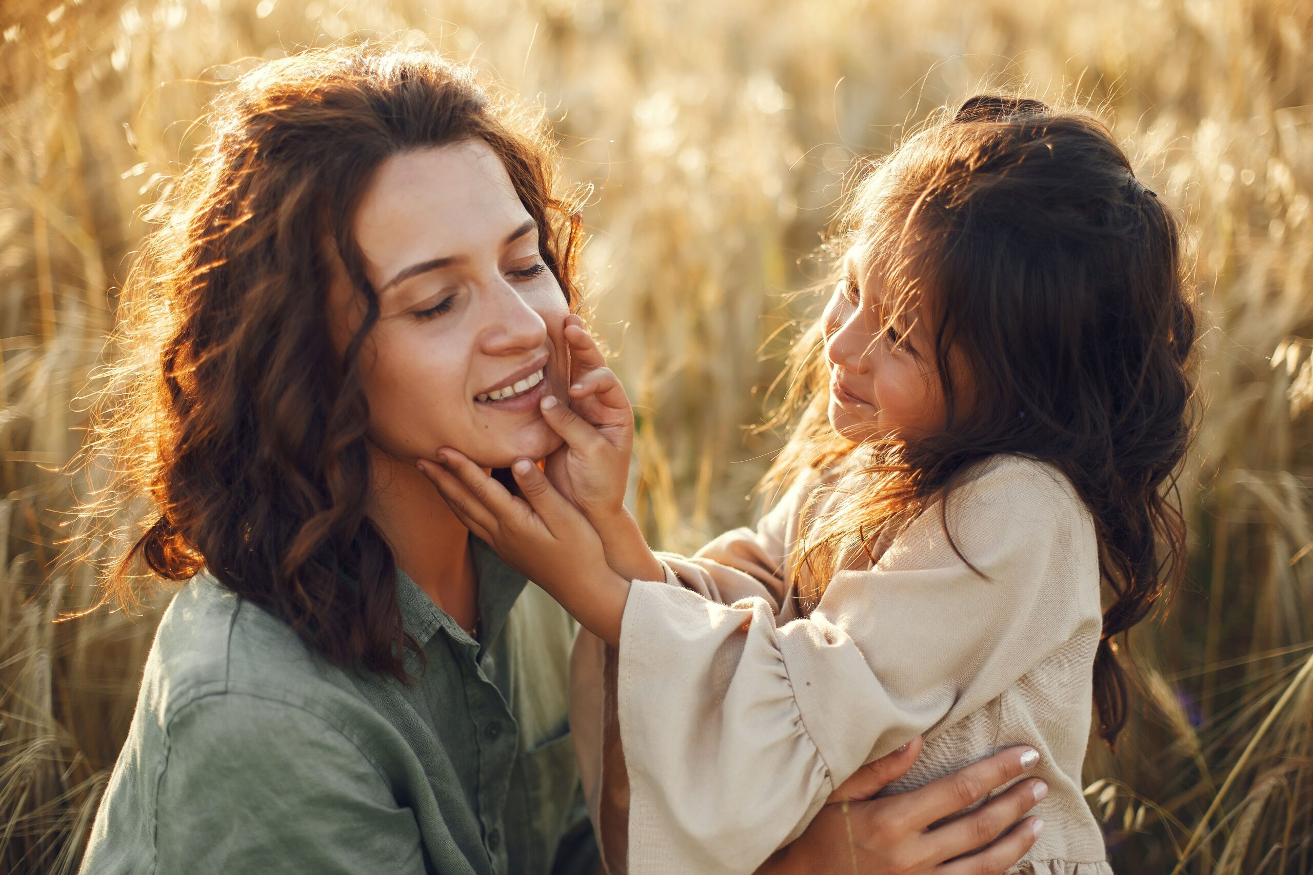 Mother and daughter embracing outdoors